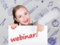 Young woman holding whiteboard with writing word: webinar. Technology, internet, business and marketing.