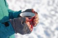 Young woman holding winter cup close up on snow background. Royalty Free Stock Photo