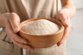 Young woman holding wooden bowl with buckwheat flour Royalty Free Stock Photo