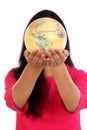 Young woman holding world globe against white