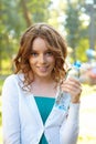 Young woman holds bottle of mineral water. Royalty Free Stock Photo