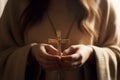 A young woman holds a cross in her hands and prays intently in a Christian church, AI generation Royalty Free Stock Photo