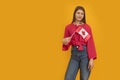 Young woman holds the flag of Canada in bright yellow background. Study in Canada. Student exchange program. Space for text