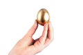 Young woman holds a golden chicken egg in her hand. Isolated Royalty Free Stock Photo