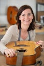 young woman holds guitar