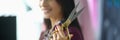 Young woman holds in hands professional seamstress scissors