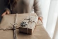 Young woman holds in hands stacked Christmas gift boxes in craft paper with juniper. Christmas presents concept Royalty Free Stock Photo