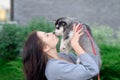 Young women holds her best friend little pet puppy of husky in her arms. love for dogs Royalty Free Stock Photo