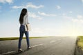 Young woman holds a laptop on the road Royalty Free Stock Photo