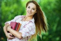 Young woman holds lot books