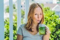 A young woman holds a mason jar in her hand with a mojito. Spring drink concept Royalty Free Stock Photo