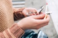 A young woman holds a mirror and lip gloss in her hands. Woman applying makeup Royalty Free Stock Photo