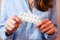 Young woman holds pills in hands. Taking vitamins, supplements, antibiotic, antidepressant, painkiller medication. Royalty Free Stock Photo