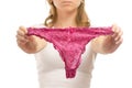 Young woman holds pink thong panties