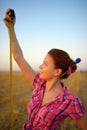 Young woman holds tapeline roulette in a hands at field