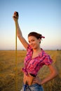 Young woman holds tapeline roulette in a hands at field