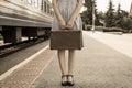 A young woman holds a vintage travel suitcase in her hands Royalty Free Stock Photo