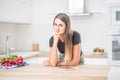 Young woman in home kitchen with tablet Royalty Free Stock Photo