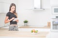 Young woman in home kitchen with tablet Royalty Free Stock Photo