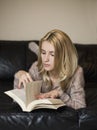 Young woman at home sitting near window relaxing in her living room Royalty Free Stock Photo