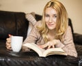 Young woman at home sitting near window relaxing in her living room Royalty Free Stock Photo