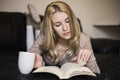 Young woman at home sitting near window relaxing in her living room Royalty Free Stock Photo