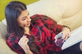 Young woman at home sitting on sofa relaxing in her living room Royalty Free Stock Photo