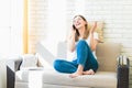 Young woman at home on sofa cheerfully speaking on phone or gossiping with her friend Royalty Free Stock Photo