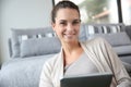 Young woman at home websurfing on tablet Royalty Free Stock Photo