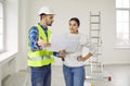 Young woman homeowner discussing design project of her new apartment with a foreman. Royalty Free Stock Photo