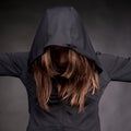 Young woman in hood with hidden