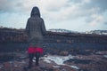 Young woman in hooded coat walking on beach Royalty Free Stock Photo