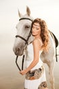 Young woman on a horse. Horseback rider, woman riding horse on b Royalty Free Stock Photo