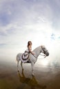 Young woman on a horse. Horseback rider, woman riding horse on b Royalty Free Stock Photo