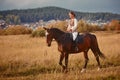 Young woman horseriding in sunset on the fields. Close up