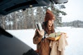 Young woman with hot drink thermos at winter forest Royalty Free Stock Photo