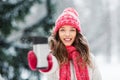 Young woman with hot drink in tumbler in winter Royalty Free Stock Photo