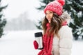 Young woman with hot drink in tumbler in winter Royalty Free Stock Photo