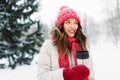 Young woman with hot drink in tumbler in winter Royalty Free Stock Photo