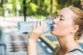 Young woman in hot weather drinks water from a bottle Royalty Free Stock Photo