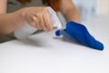 Close up of housekeeper cleaning white table, sanitizing table surface with disinfectant antibacterial spray bottle Royalty Free Stock Photo