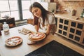 Young woman housewife baking homemade pizza Royalty Free Stock Photo