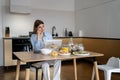 Female freelancer making business call while working remotely from home Royalty Free Stock Photo