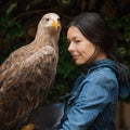 A young woman with a huge mountain eagle on her glove,