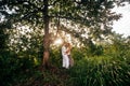 Young woman hugging asian man in the middle of a wheat field and kissing each other. Royalty Free Stock Photo