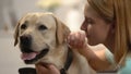 Young woman hugging dog, emotional pet connection, happy labrador owner, love