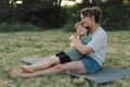 Young woman hugging her little son at sunny in the meadow. Royalty Free Stock Photo