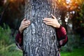 Young woman hugging tree trunk. concept of nature preservation and ecology Royalty Free Stock Photo