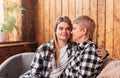 Young woman hugs her mom sitting on the couch in the room