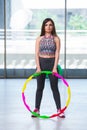 The young woman with hula loop in gym in health concept Royalty Free Stock Photo